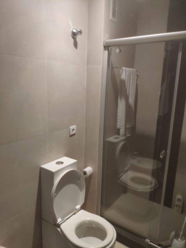 Baño con mampara de ducha e inodoro
